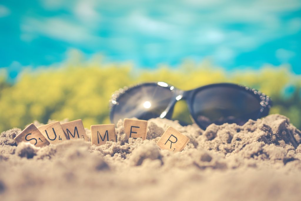 Sunglasses and summer letters on the beach