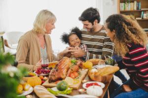 Grateful Family around Table Sharing Food Together